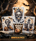Gothic skeleton Lenormand card deck "Bones of Fate" spread on a table with candles, handmade in Ukraine. Close-up of three cards from the Bones of Fate esoteric card set: the Dog, the Stars, and the Tower. The cards feature gothic skull and skeleton illustrations and are displayed on a spooky skeletal hand stand. The background includes a full moon, dark branches, a dried rose, and small metal bat charms